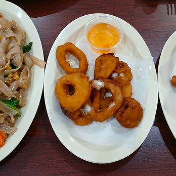 Noppagao Thai Cuisine - From left: Pork pad see ew, calamari, and egg rolls. - Thai Near Me - San Antonio, Texas Noppagao Thai Cuisine - From left: Pork pad see ew, calamari, and egg rolls. - Thai Near Me - San Antonio, Texas