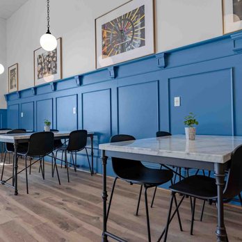 Summer Moon Coffee - tables and chairs against a blue wall - Coffee & Tea Near Me - Wake Forest, North Carolina Summer Moon Coffee - tables and chairs against a blue wall - Coffee & Tea Near Me - Wake Forest, North Carolina