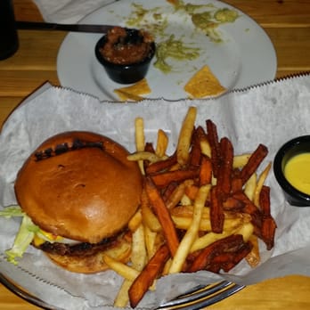 LoKal - Classic burger with remnants of the Homestead Avocado mix behind it. - Burgers Near Me - Miami, Florida