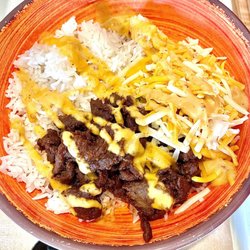 Chi'Lantro - White rice, steak, queso, cheese.