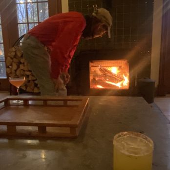 Hotel Lilien - a man standing over a table with a glass of orange juice - Bars Near Me - Hunter, New York Hotel Lilien - a man standing over a table with a glass of orange juice - Bars Near Me - Hunter, New York