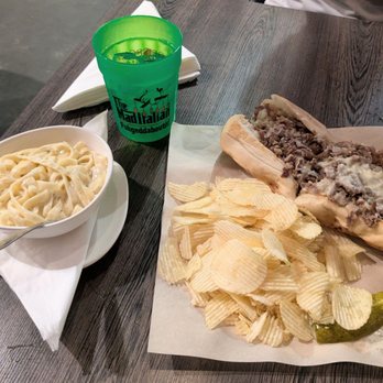The Mad Italian - Fettuccine with alfredo sauce for the side. The big daddy cheese steak on the right. - Italian Near Me - Chamblee, Georgia