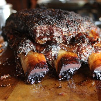 Outpost 36 - a pork roast on a wooden cutting board - Barbeque Near Me - Keller, Texas Outpost 36 - a pork roast on a wooden cutting board - Barbeque Near Me - Keller, Texas