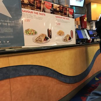Osmow's Shawarma - a man sitting at a counter - Mediterranean Near Me - Brampton, Ontario