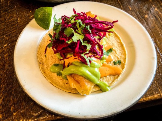 Photo of Campechano Taquería - Toronto, ON, CA. Fried haddock taco with red cabbage and cilantro