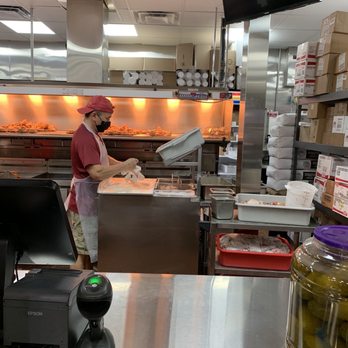 Lisa’s Chicken - a woman working in a commercial kitchen - Fast Food Near Me - Crowley, Texas Lisa’s Chicken - a woman working in a commercial kitchen - Fast Food Near Me - Crowley, Texas