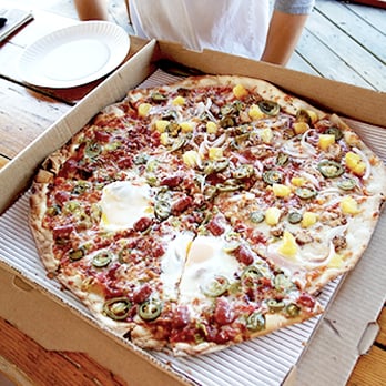 East Side Pies - half Old 97s with fried egg, half Jamaican - Pizza Near Me - Austin, Texas