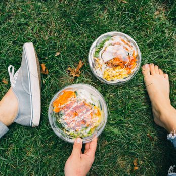 Poke Bros - two people holding bowls of food - Poke Near Me - South Elgin, Illinois