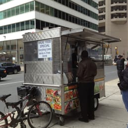 a food cart on a city street a food cart on a city street