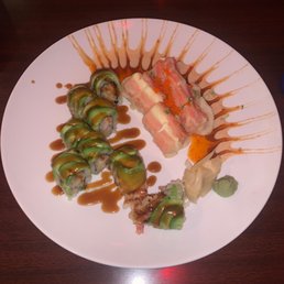 Shrimp tempura with avocado on top, and a ricky roll Shrimp tempura with avocado on top, and a ricky roll