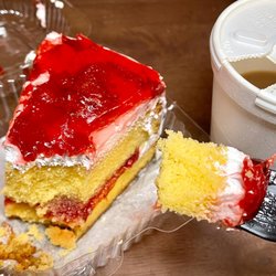 Slice of strawberry cake and coffee
