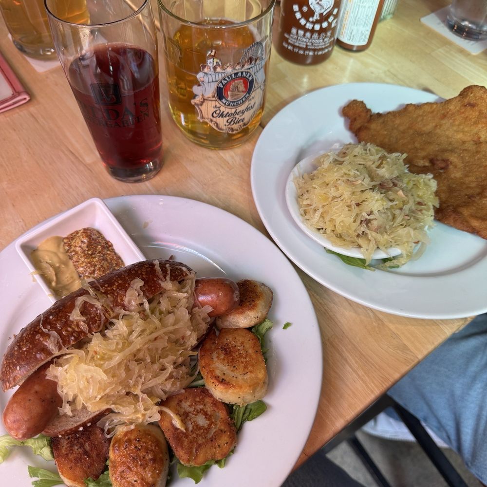 Beda's Biergarten - jager schnitzel and sauerkraut on the right weisswurt on pretzel bun and knodel on the left - German Near Me - San Luis Obispo, California Beda's Biergarten - jager schnitzel and sauerkraut on the right weisswurt on pretzel bun and knodel on the left - German Near Me - San Luis Obispo, California