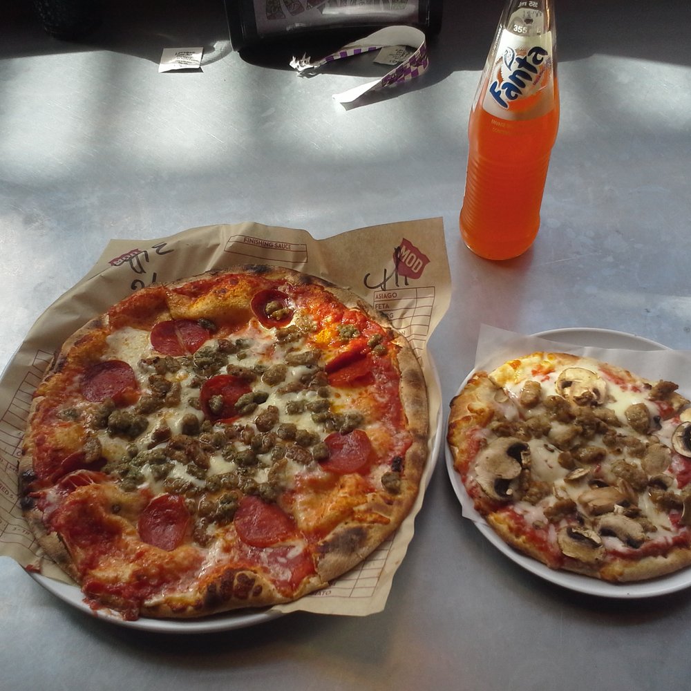 MOD Pizza - In the left corner, weighing in a 11 inches, the MOD 'Mad Dog'. In the right corner, tipping the scales at 6 inches, a mini sausage/mushrm! - Pizza Near Me - Austin, Texas MOD Pizza - In the left corner, weighing in a 11 inches, the MOD 'Mad Dog'. In the right corner, tipping the scales at 6 inches, a mini sausage/mushrm! - Pizza Near Me - Austin, Texas