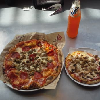 MOD Pizza - In the left corner, weighing in a 11 inches, the MOD 'Mad Dog'. In the right corner, tipping the scales at 6 inches, a mini sausage/mushrm! - Pizza Near Me - Austin, Texas
