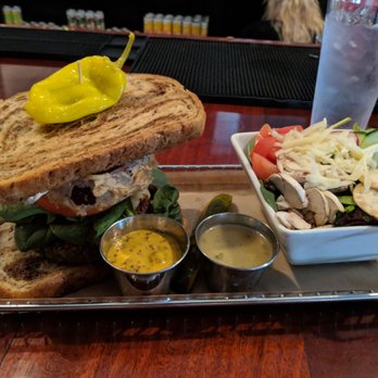 Hops Burger Bar - Nut burger with spinach tomato fried onion rings and side salad ( It was build your own burger) - Burgers Near Me - Greensboro, North Carolina Hops Burger Bar - Nut burger with spinach tomato fried onion rings and side salad ( It was build your own burger) - Burgers Near Me - Greensboro, North Carolina