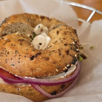 Bagel Cafe - Toasted Whole Wheat Italian Seasonings Bagel with Tofutti (R), Tomato, Red Onion, and Sprouts - Sandwiches Near Me - Camden, Maine Bagel Cafe - Toasted Whole Wheat Italian Seasonings Bagel with Tofutti (R), Tomato, Red Onion, and Sprouts - Sandwiches Near Me - Camden, Maine