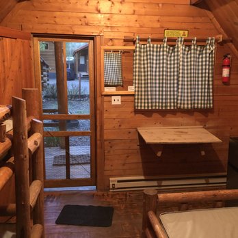 Jackson Hole / Snake River KOA - View of cabin with a little table and mini fridge facing the door/porch area. - Campgrounds Near Me - Jackson, Wyoming Jackson Hole / Snake River KOA - View of cabin with a little table and mini fridge facing the door/porch area. - Campgrounds Near Me - Jackson, Wyoming
