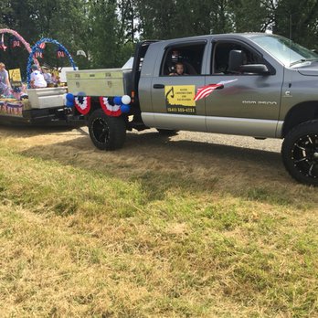 Bates Construction and Excavation - a truck with a float in the back - Excavation Services Near Me