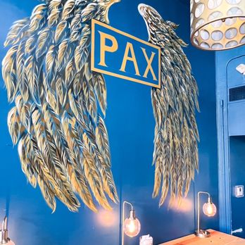 PAX Coffee & Goods - a mural of a pair of wings - Coffee & Tea Near Me - Kerrville, Texas