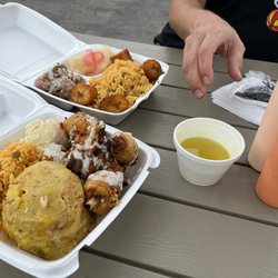 El Coqui - Both of our meals along with the dipping broth for the Mofongos and the two side sauces.  The portion sizes were epic!