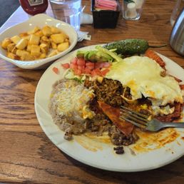 Chilaquilies with chorizo and side of home fries Chilaquilies with chorizo and side of home fries