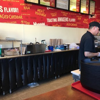 Quiznos - a man working in a fast food restaurant - Sandwiches Near Me - The Woodlands, Texas