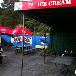 Huia Beach Store & Cafe - Outdoor seating at Huia beach cafe
