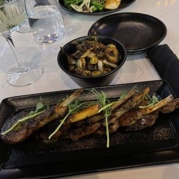 BLK SWAN - Lamb chops and Brussels sprouts. Salmon dish in the back. - New American Near Me - Baltimore, Maryland BLK SWAN - Lamb chops and Brussels sprouts. Salmon dish in the back. - New American Near Me - Baltimore, Maryland