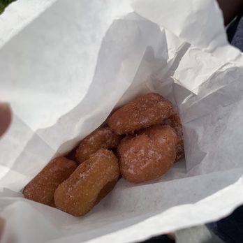 Neighborgood Markets - a person holding a bag of doughnuts - Farmers Market Near Me - Elk Grove, California Neighborgood Markets - a person holding a bag of doughnuts - Farmers Market Near Me - Elk Grove, California
