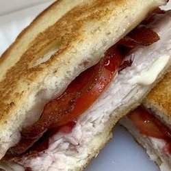 Here & There Grill - Grilled Turkey Sandwich with bacon, tomato, cranberry sauce and havarti