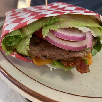 Stockton's Restaurant & Spirits - a burger wrapped in a checkered paper - Bars Near Me - Maple Valley, Washington