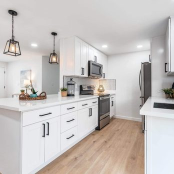 Vasa Construction - a kitchen with white cabinets and stainless steel appliances - Roofing Near Me - Seattle, Washington Vasa Construction - a kitchen with white cabinets and stainless steel appliances - Roofing Near Me - Seattle, Washington