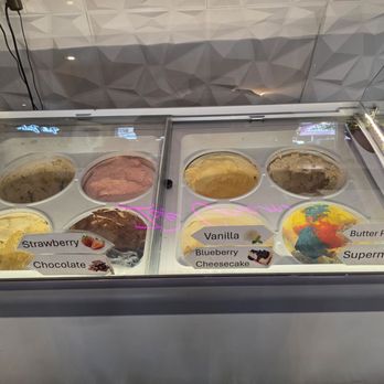 Dells Bistro - Ice cream - A freezer contains various ice cream flavors with labels including strawberry, chocolate, vanilla, blueberry cheesecake, butter pecan, and Superman. - Breakfast & Brunch Near Me - Wisconsin Dells, Wisconsin