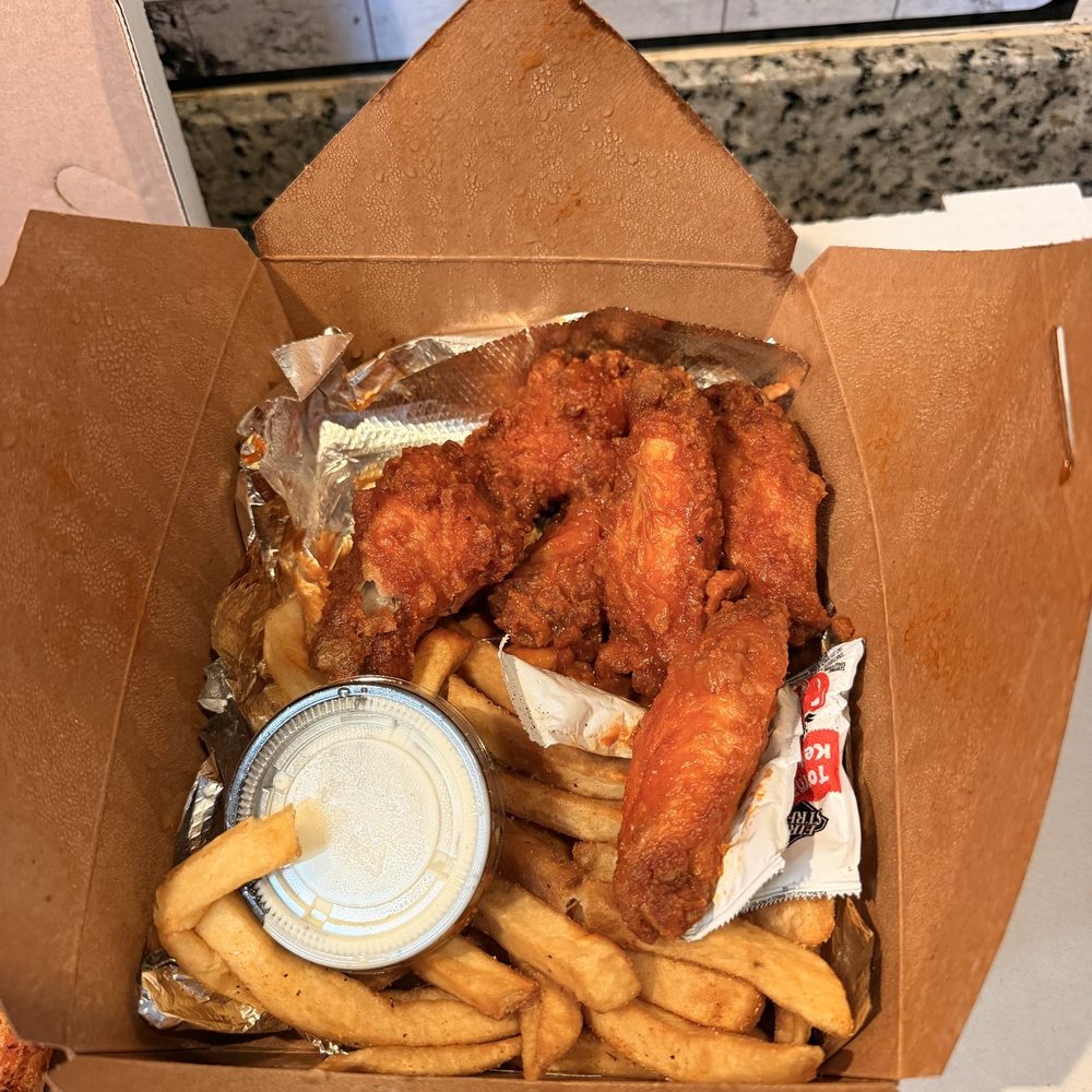 Buffalo wings with French fries and ranch dressing