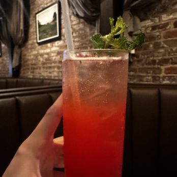 Nic & Norman's - a person holding a drink - American Near Me - Louisville, Kentucky