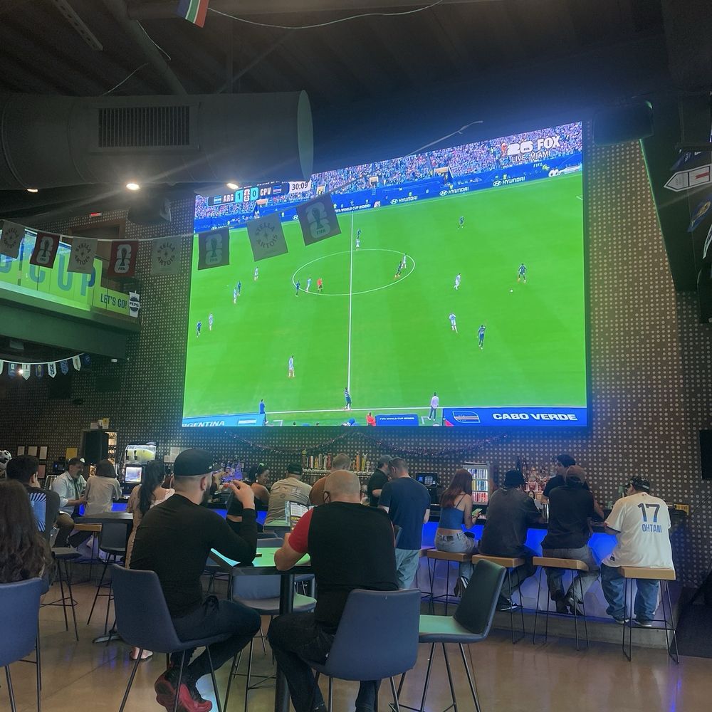 Topgolf - Bar Area Big Screen With Soccer Game - Golf Near Me - Montebello, California Topgolf - Bar Area Big Screen With Soccer Game - Golf Near Me - Montebello, California