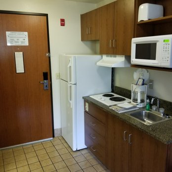 Home Towne Suites - floor, fridge, stove top, coffee pot clean. 2 of everything on dishes and silverware. Dish soap as well as 2 mints  on the pot holder. - Hotels Near Me - O'Fallon, Illinois