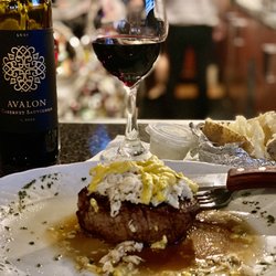 Theo's Steaks & Seafood - Theo's Special Filet. Filet topped with crabmeat, and their chefs bearnaise sauce. Baked potato and glass of wine. Divine!