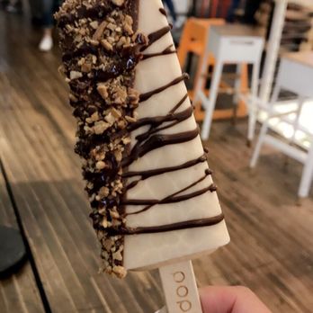 Popbar - Hazelnut bar, half dipped in milk chocolate, drizzled in dark chocolate, topped with waffle crumbs - Desserts Near Me - Anaheim, California Popbar - Hazelnut bar, half dipped in milk chocolate, drizzled in dark chocolate, topped with waffle crumbs - Desserts Near Me - Anaheim, California