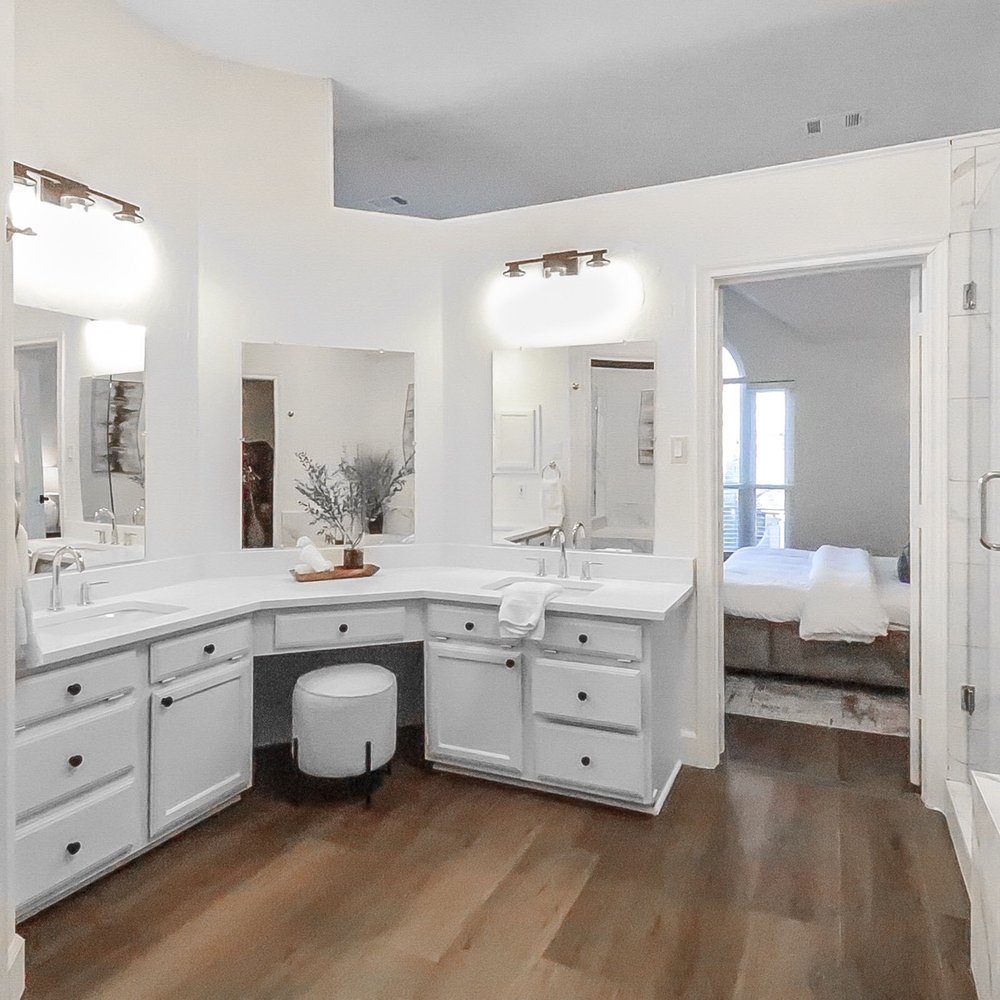 Masters Contracting - a bathroom with a double vanity and a walk - in shower - General Contractors Near Me - Grand Prairie, Texas