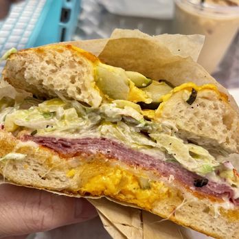 Hidden Bagel - a person holding a sandwich - Bagels Near Me - Spokane, Washington Hidden Bagel - a person holding a sandwich - Bagels Near Me - Spokane, Washington