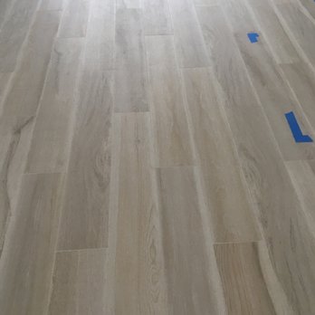 BPL Design Group - a hardwood floor with blue tape - General Contractors Near Me - Stuart, Florida