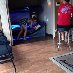 Aruba Beach Tanning Studio - Staff cleaning bed. Not the one who told me I could put on hold - no staff seems to last longer than few months.