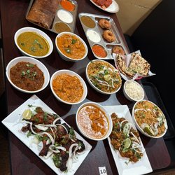 The Hyderabad indian Grill - A delicious spread of authentic Indian dishes, including biryanis, curries, tandoori starters, dosa, breads, and a variety of chutneys and s