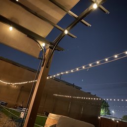 a patio with string lights