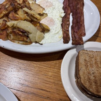 Yanna's Cafe - Two eggs over easy, four strips of bacon, toast, and potatoes. - Breakfast & Brunch Near Me - Lakewood, Colorado Yanna's Cafe - Two eggs over easy, four strips of bacon, toast, and potatoes. - Breakfast & Brunch Near Me - Lakewood, Colorado
