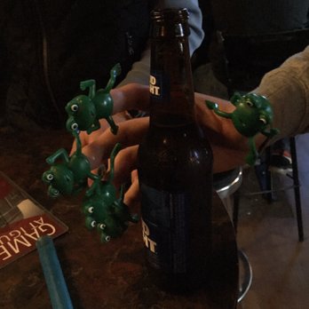 Iguana's Pub - a bottle of beer with frogs on it - Pubs Near Me - Lincoln, Nebraska