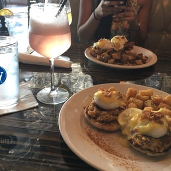 Bay Local Eatery - Jumbo strawberry sorbet mimosa ($7.99) and crab cake benny. Bay local benny in back ($12.99) - New American Near Me - Virginia Beach, Virginia