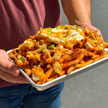 FOMO Fries - a man holding a tray of fries - Food Delivery Services Near Me - Cypress, California FOMO Fries - a man holding a tray of fries - Food Delivery Services Near Me - Cypress, California