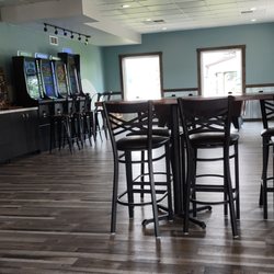Alchemy Brewing - Pool table, games & door out to a covered patio